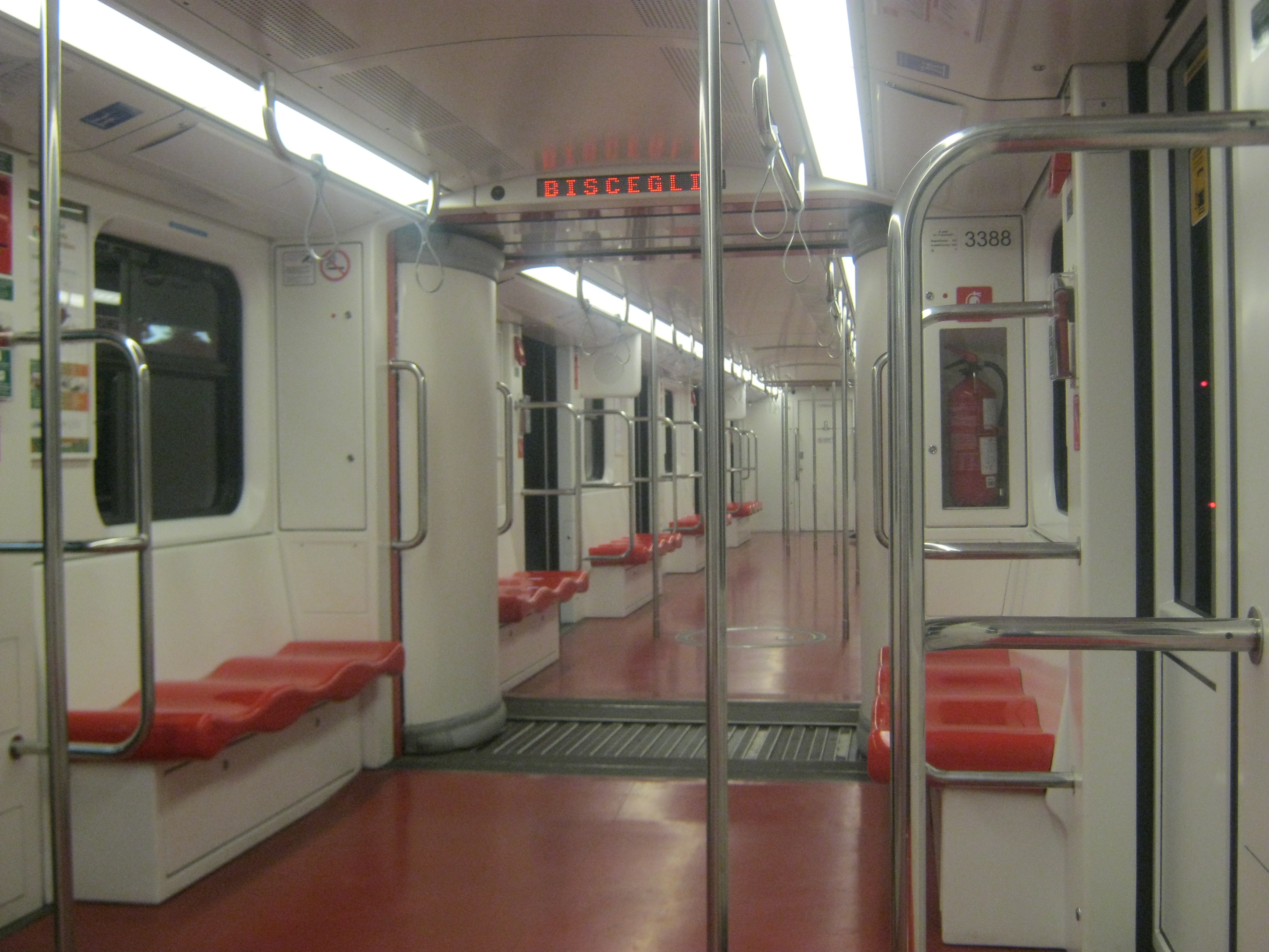 The inside of a red and white empty tram